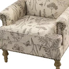 Fauteuil rembourré en bois avec motif floral, accoudoirs à panneaux et dossier en forme de bosse de chameau.