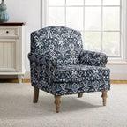 Fauteuil rembourré en bois avec motif floral, accoudoirs à panneaux et dossier en forme de bosse de chameau.